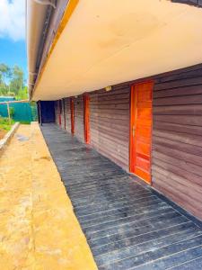 a row of wooden doors on the side of a building at Ol eburru cottage budget rooms in Gilgil