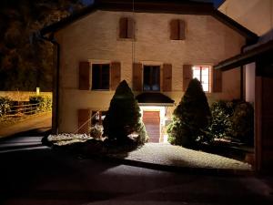 a house with two trees in front of it at La Chambre in Colombier