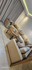 a room with two tables and chairs and a ceiling at Costamar Martil in Martil +12 photos