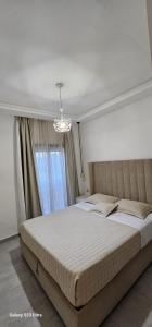 a bedroom with a large bed in front of a window at Costamar Martil in Martil