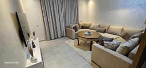 a living room with a couch and a table at Costamar Martil in Martil