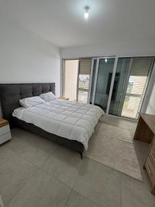 a bedroom with a large bed and a large window at Amazing vacation villa in paphos 3 Bedrooms in Chlorakas +70 photos