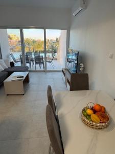a bowl of fruit on a table in a living room at Amazing vacation villa in paphos 3 Bedrooms in Chlorakas