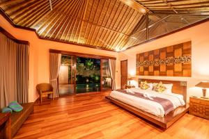 a bedroom with a large bed in a room at The Kampung Ubud Villa in Ubud +78 photos