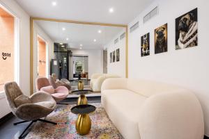 a living room with a white couch and chairs at htop BCN - City in Barcelona