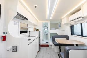 a kitchen and dining area of an rv with a table at Almaengyi Caravan Glamping in Pocheon +10 photos