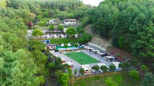 an aerial view of a golf course in a hill at Almaengyi Caravan Glamping in Pocheon