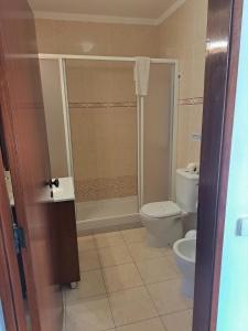 a bathroom with a toilet and a shower at Mira Parque in Albufeira