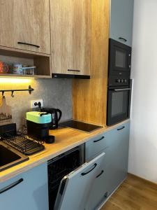 a kitchen with a coffee maker on a counter at Apartman Njegoš Lux Titova vila in Palisad
