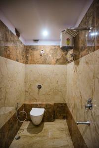 a bathroom with a toilet and a shower at Sapphire By the Ganges in Prayagraj