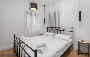 a bedroom with a black bed with white sheets and pillows at Charming Holiday Home with private heated pool in Jakišnica +45 photos