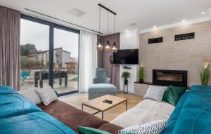 a living room with a blue couch and a fireplace at Charming Holiday Home with private heated pool in Jakišnica