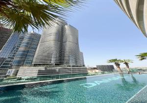 a view of a tall building with a swimming pool at Nice 2 Bedroom Apartment! 5 Minute walk to Dubai Mall! Burj Khalifa View! in Dubai +57 photos