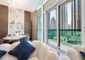 a room with a table and chairs and a large window at Nice 2 Bedroom Apartment! 5 Minute walk to Dubai Mall! Burj Khalifa View! in Dubai