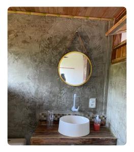 a bathroom with a sink and a mirror on the wall at Igapeba Hospedaria em Moreré in Cairu