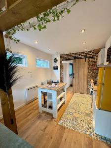 a kitchen with a table in the middle of a room at Au Ch'ti Cosy in Roubaix