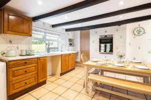a kitchen with a table and a dining room at Rigg Farm Cottage - NR Whitby in Stainsacre