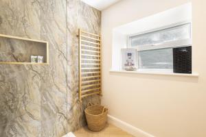 a bathroom with a stone wall and a window at Rigg Farm Cottage - NR Whitby in Stainsacre +56 photos