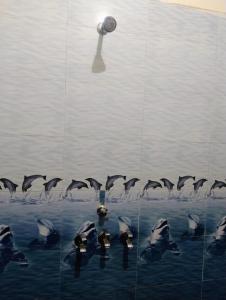 a flock of dolphins swimming in the water at Ganga Homestay in Prayagraj