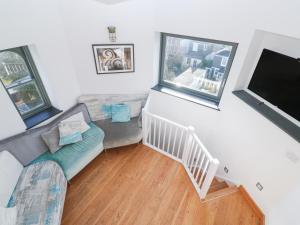 a living room with a couch and a flat screen tv at The Observatory Tower in Falmouth