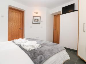 a bedroom with a bed with towels on it at The Observatory Tower in Falmouth