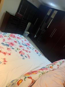 a bedroom with two beds with flowers on the sheets at Khosana travel and tours in Pimville