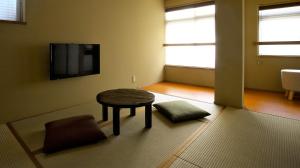 a living room with a table and a tv at "NAGOMI"Kyoto Okazaki 京都岡崎の町家 和 in Kyoto
