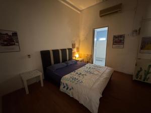 a bedroom with a bed and a table and a window at Wi-Fi 100MB free Ipoh Town Holiday House Tmn Shatin S36 in Ipoh