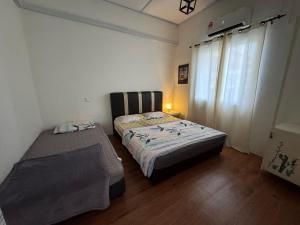 a small bedroom with a bed and a window at Wi-Fi 100MB free Ipoh Town Holiday House Tmn Shatin S36 in Ipoh