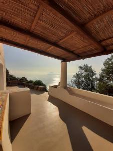a view of a balcony with a wooden roof at L'Olivuzza in Alicudi +19 photos