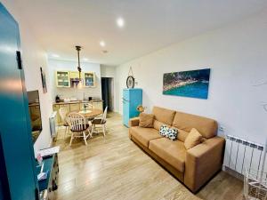 a living room with a couch and a table at Apartamentos Las Alas in Cartes