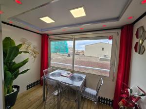 a dining room with a table and a window at C12 Deluxe in Cap d'Agde