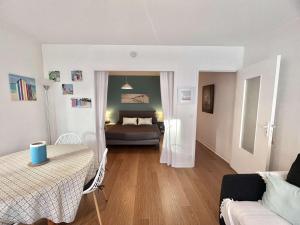 a living room with a bed and a couch at Appartement 3* à Bénodet, terrasse, parking, à 150m de la plage et thalasso - FR-1-481-49 in Bénodet