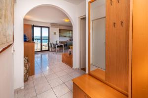 a kitchen and living room with a view of the ocean at Biserka 2 with stunning sea view in Punat +15 photos