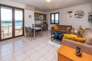 a living room with a couch and a table at Biserka 2 with stunning sea view in Punat