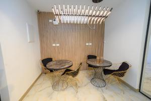 a dining room with two tables and chairs at מלון סול in Tiberias