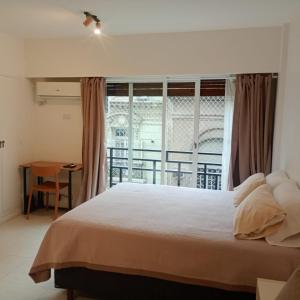 Ένα ή περισσότερα κρεβάτια σε δωμάτιο στο Excelente departamento céntrico cerca de todo