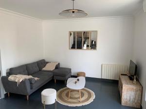 a living room with a couch and a table at Hébergement Guer in Guer