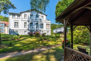 a view of a house from a porch at Ostseehotel Villen im Park - ein Rovell Hotel in Bansin