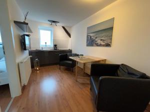 a living room with a couch and a table at Ferienwohnung West in Fehmarn