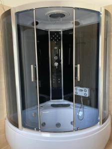 a small shower in a room with glass at Archontiko Dagmar in Áyioi Apóstoloi