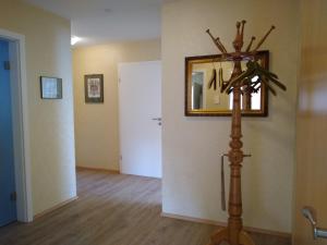 a room with a mirror and a wooden floor at Burgblick-Fewo Töpfer in Annweiler am Trifels