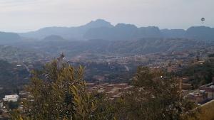 a view of a city with mountains in the background at WaterMill House in Wadi Musa +9 photos