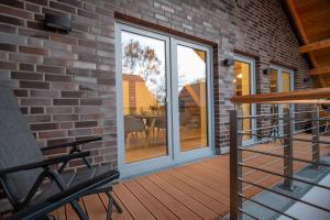a sliding glass door on a patio with a table at FerienhausPenthouse Captain's Bridge in Pellworm