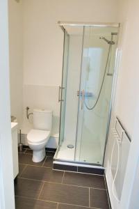 a bathroom with a toilet and a glass shower at Segellast 2 in Lübeck