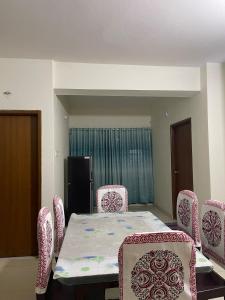 a dining room with a table and chairs at Modern Furnished Apartment in Uttara Near Metro in Dhaka