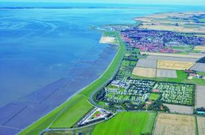 an aerial view of a city next to the water at Kleine Nordseewelle ohne Hund in Norden +3 photos