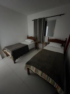 Ένα ή περισσότερα κρεβάτια σε δωμάτιο στο Apartamento no Centro de Jacumã 2 Quartos