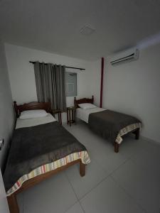 Ένα ή περισσότερα κρεβάτια σε δωμάτιο στο Apartamento no Centro de Jacumã 2 Quartos