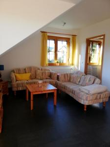 a living room with two couches and a coffee table at Harzwellness in Altenau